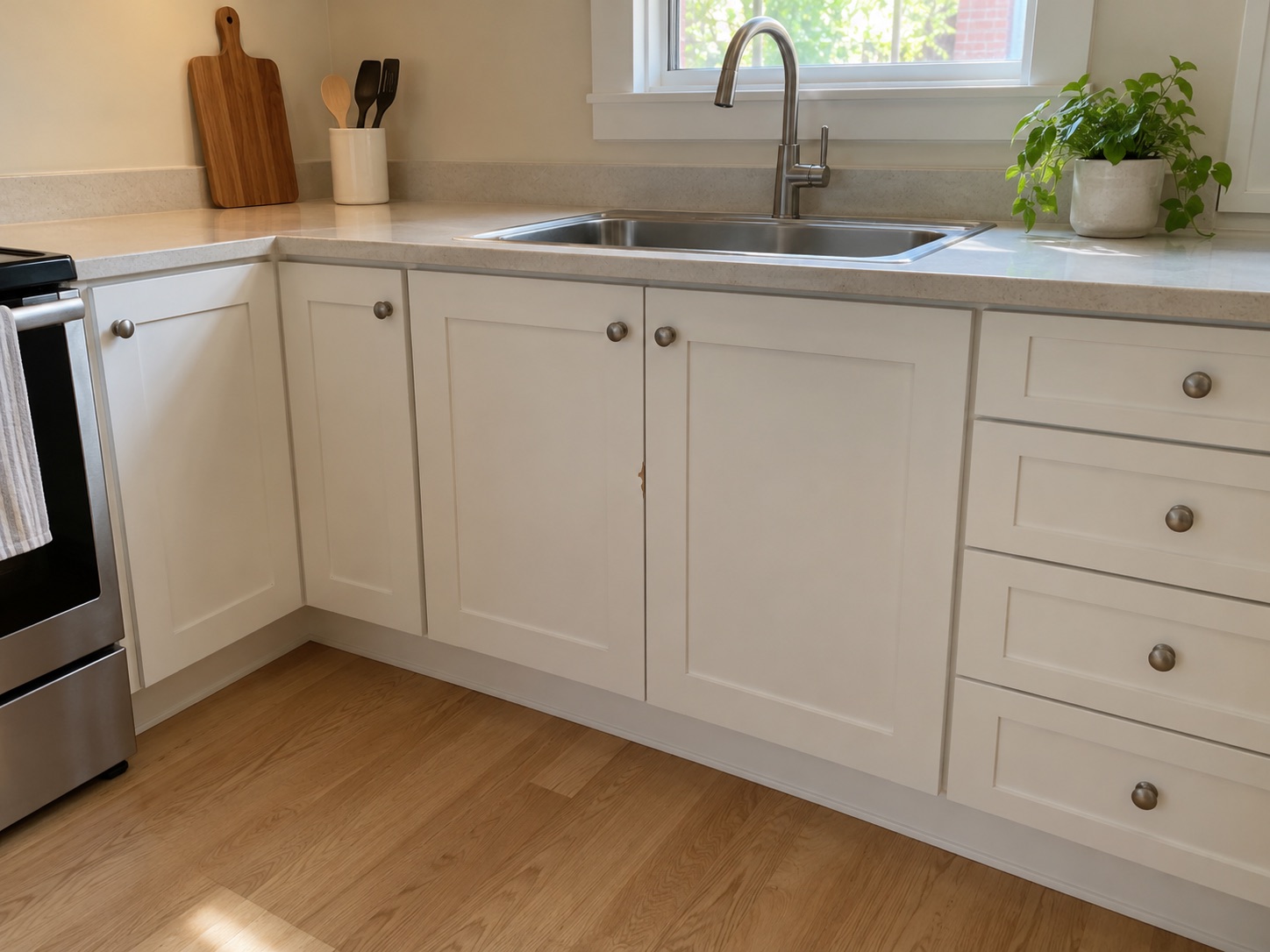Sample apartment kitchen with a small paint chip on a lower cabinet
